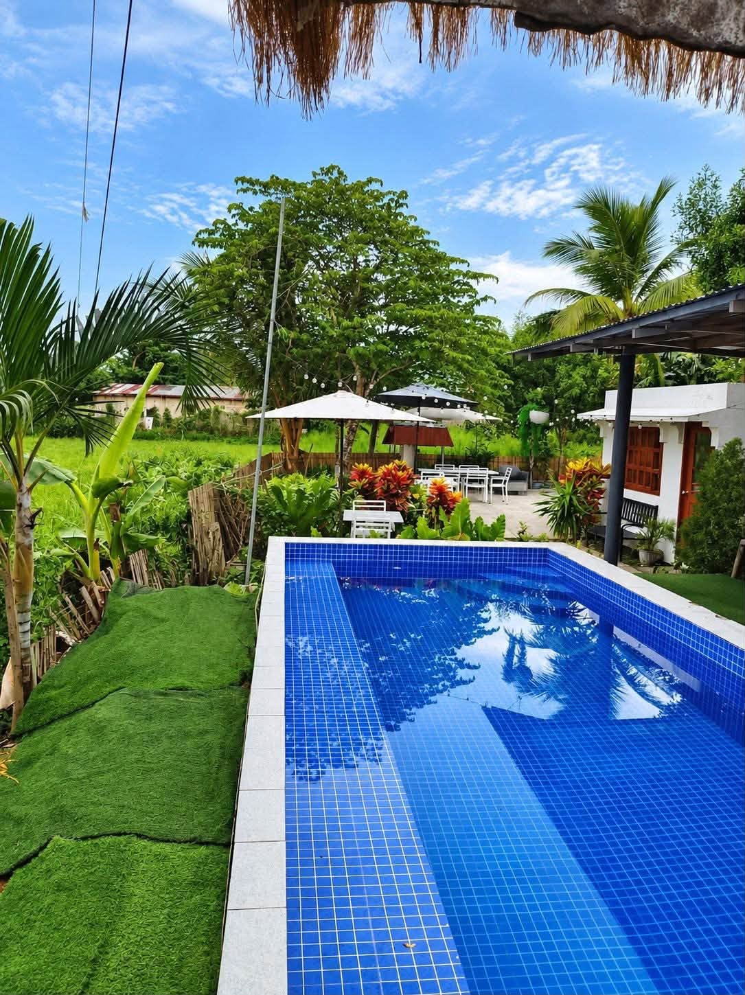 Private blue swimming pool included in the daytime package